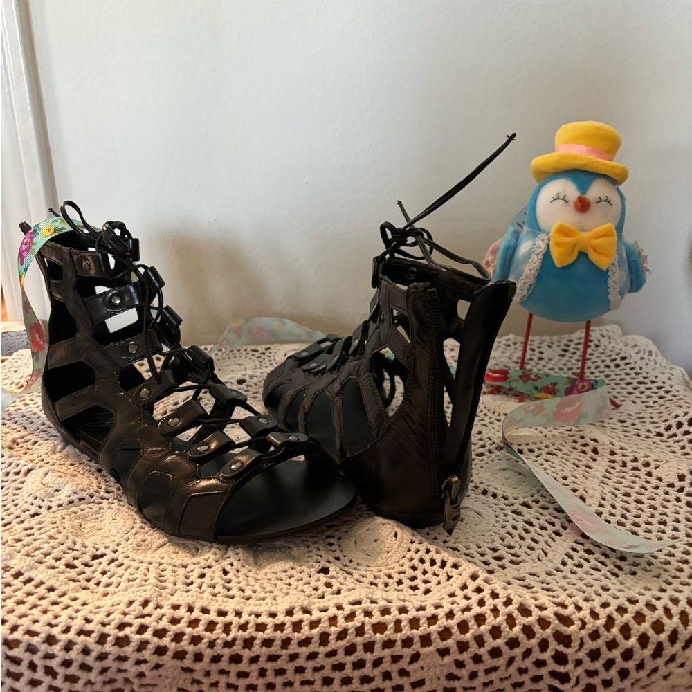 Black gladiator low heel ankle wrap sandals by FERGIE.